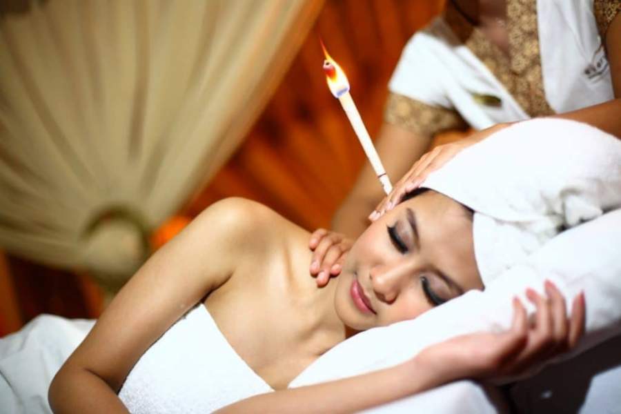 Candling to remove wax from ears